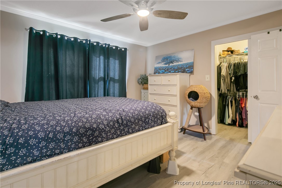 7666 Overhills Road Spring Lake, NC 28390 - Photo 28 of 50 a bed sitting in a bedroom and bathroom