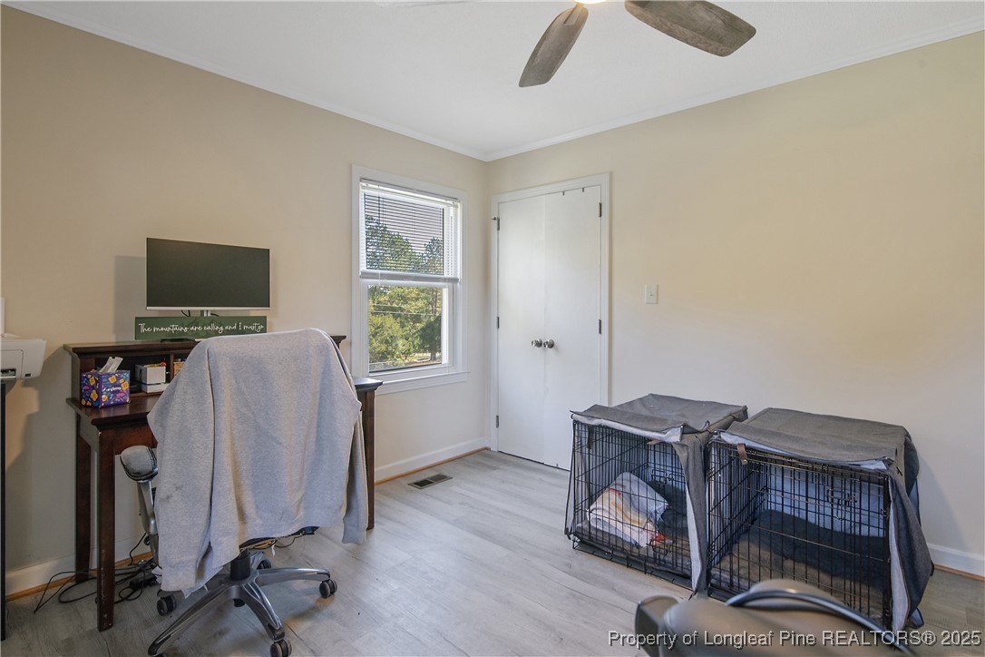 7666 Overhills Road Spring Lake, NC 28390 - Photo 38 of 50 a view of a workspace with furniture and a window