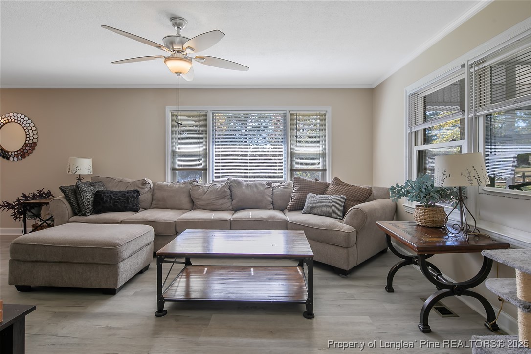 7666 Overhills Road Spring Lake, NC 28390 - Photo 10 of 50 a living room with furniture a large window and a coffee table