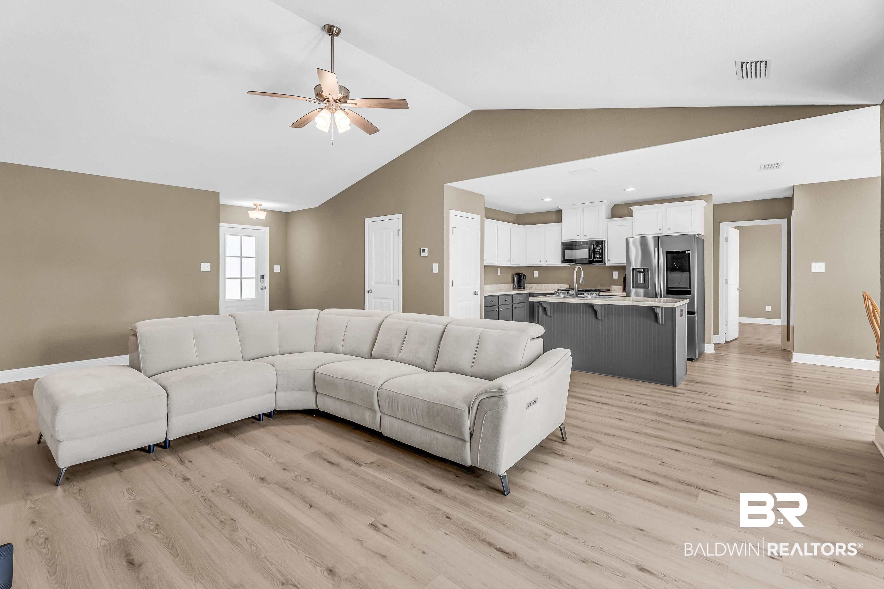 9206 Greenleaf Drive Daphne, AL 36527 - Photo 3 of 32 Living room featuring light wood-type flooring, ceiling fan, and high vaulted ceiling