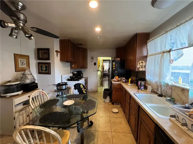 a kitchen with sink refrigerator and stove
