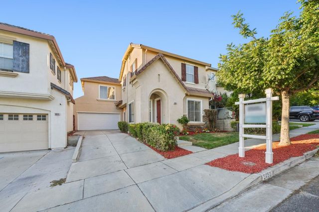 a view of a white house with a yard