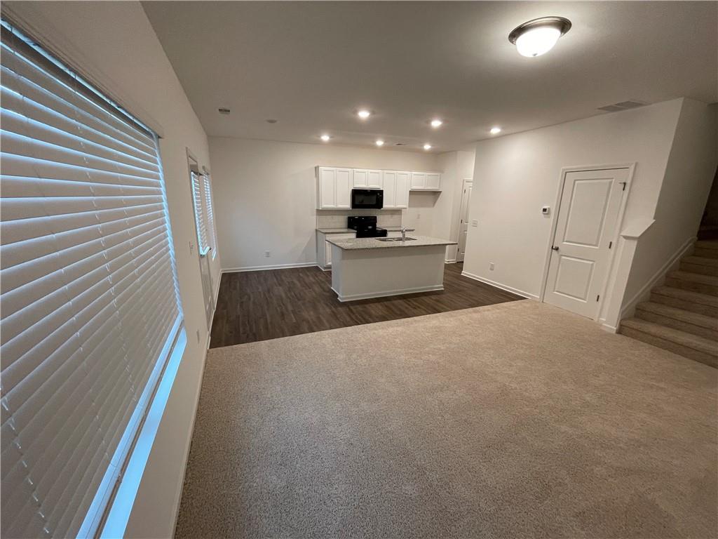 1003 Ramon Drive Grayson, GA 30017 - Photo 2 of 12 a living room with stainless steel appliances furniture and a fireplace