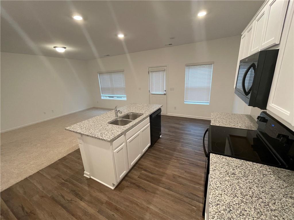 1003 Ramon Drive Grayson, GA 30017 - Photo 5 of 12 a kitchen with a stove and a refrigerator