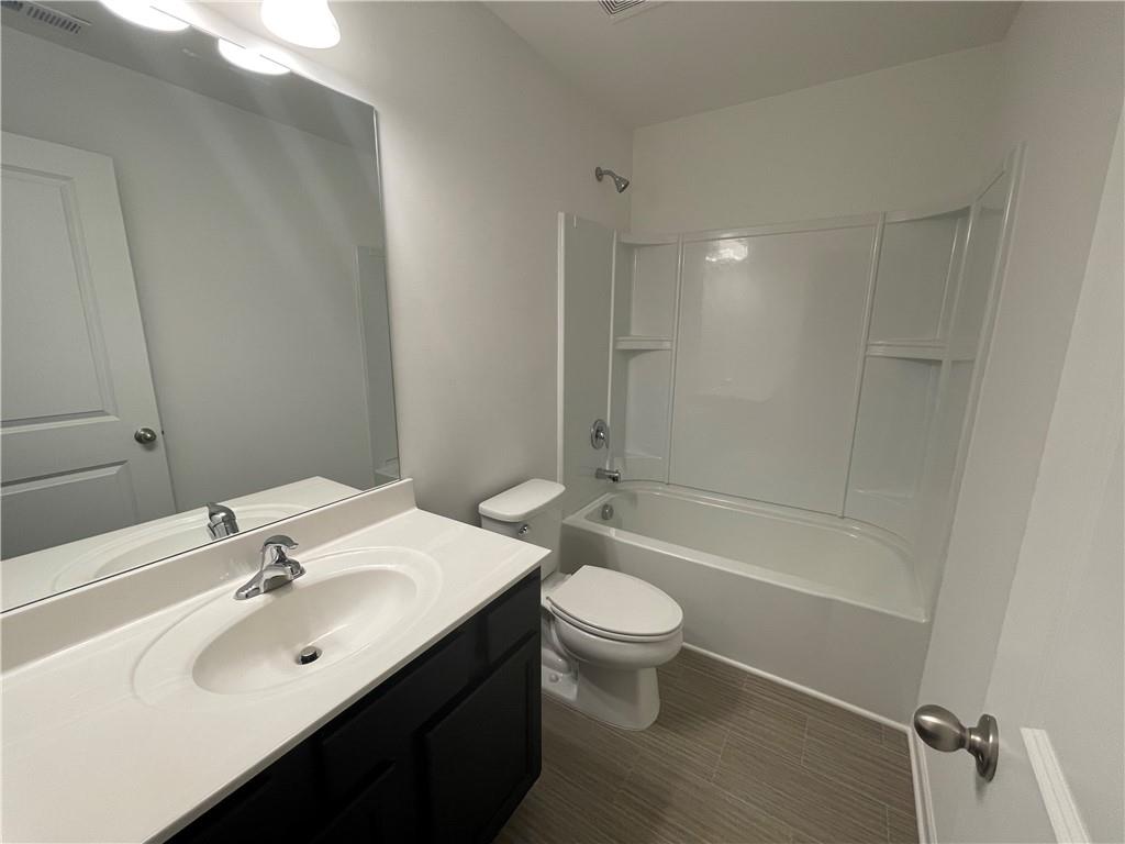 1003 Ramon Drive Grayson, GA 30017 - Photo 6 of 12 a bathroom with a sink a toilet and shower