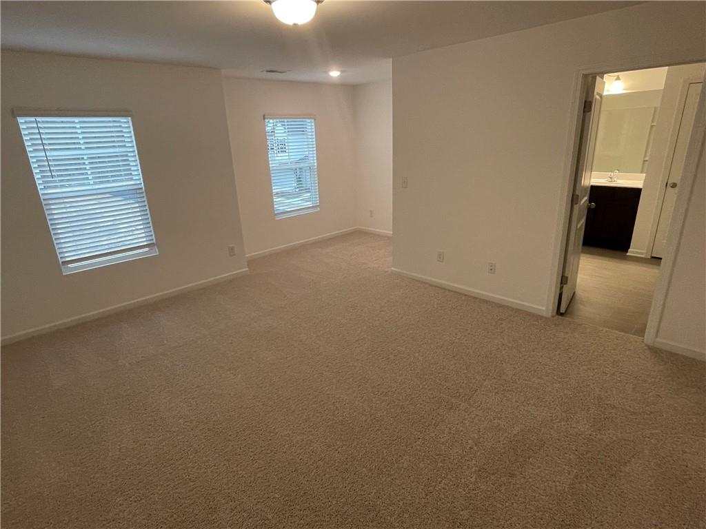1003 Ramon Drive Grayson, GA 30017 - Photo 8 of 12 an empty room with windows