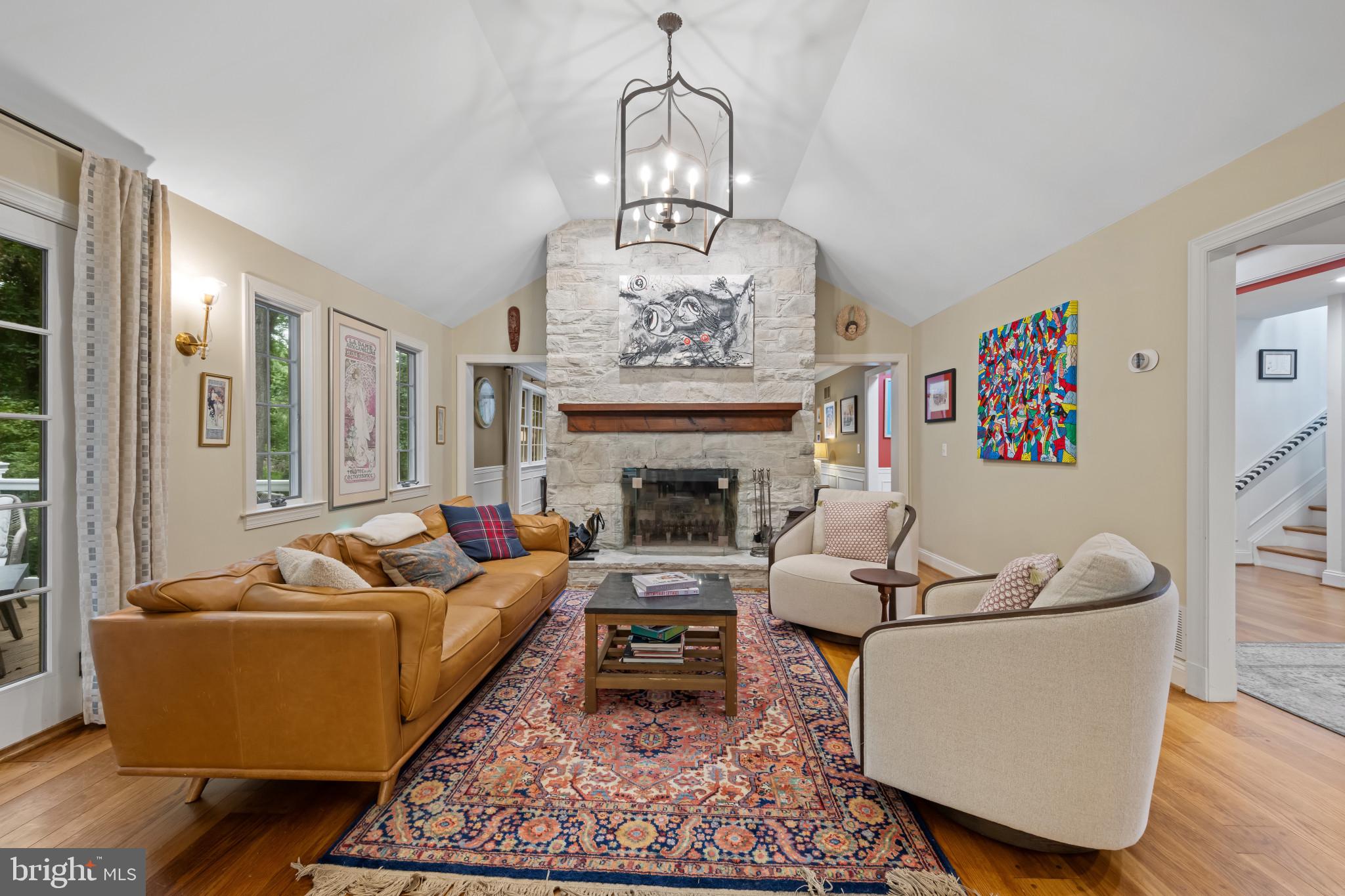 901 Navy Road Baltimore, MD 21204 - Photo 10 of 40 a living room with furniture a fireplace and a chandelier