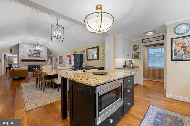 a kitchen with cabinets and wooden floor