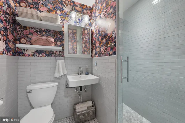 a bathroom with a toilet sink and mirror