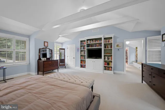 a bedroom with furniture and windows