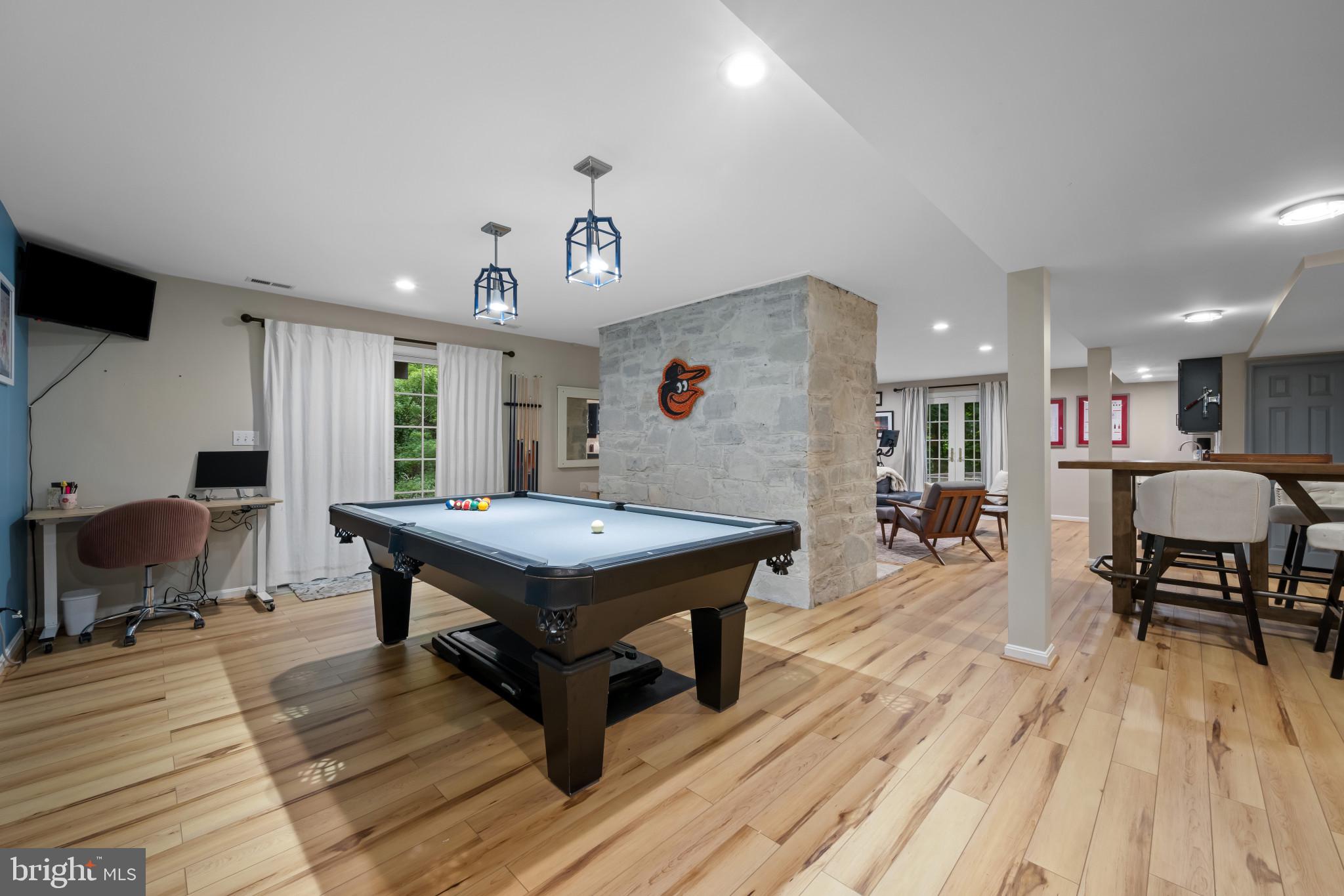 901 Navy Road Baltimore, MD 21204 - Photo 27 of 40 a room with wooden floor and pool table