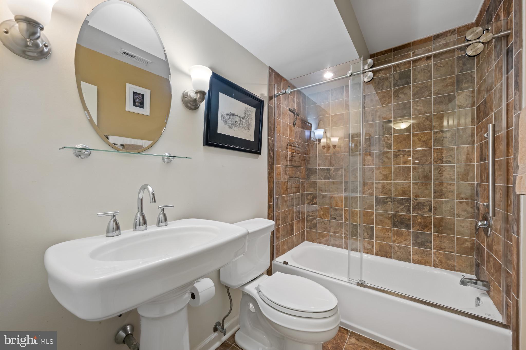 901 Navy Road Baltimore, MD 21204 - Photo 32 of 40 a bathroom with a sink mirror toilet and bathtub