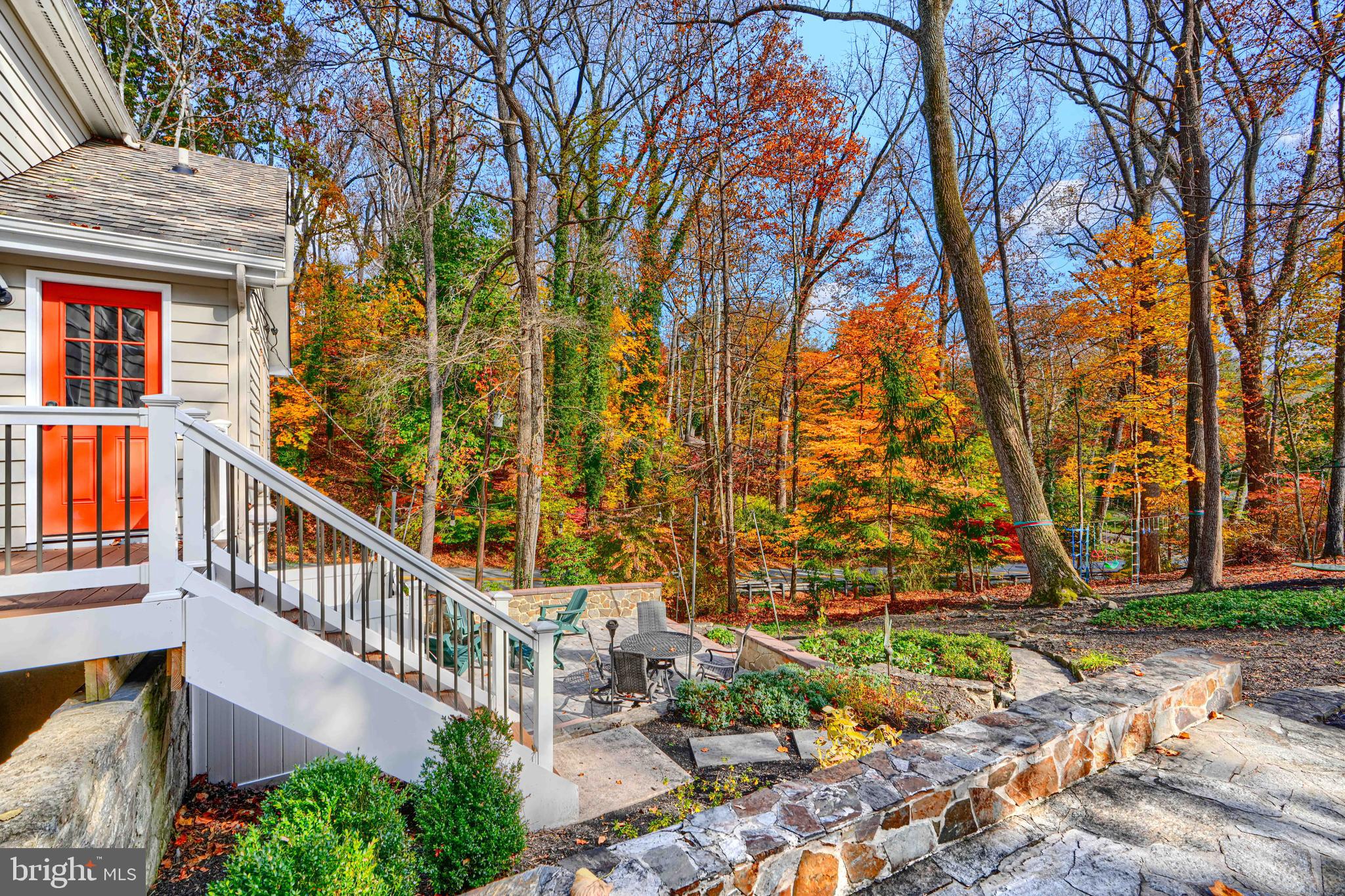 901 Navy Road Baltimore, MD 21204 - Photo 34 of 40 a view of a house with large trees and a wooden deck