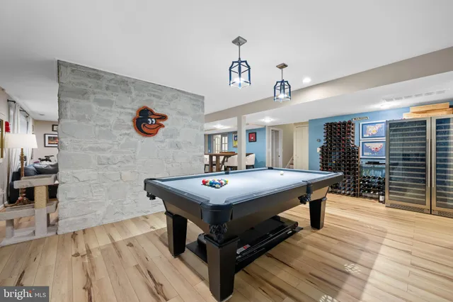 a living room with furniture a flat screen tv and a window