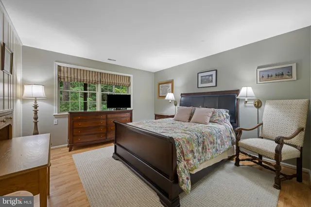a room with wooden floor and pool table