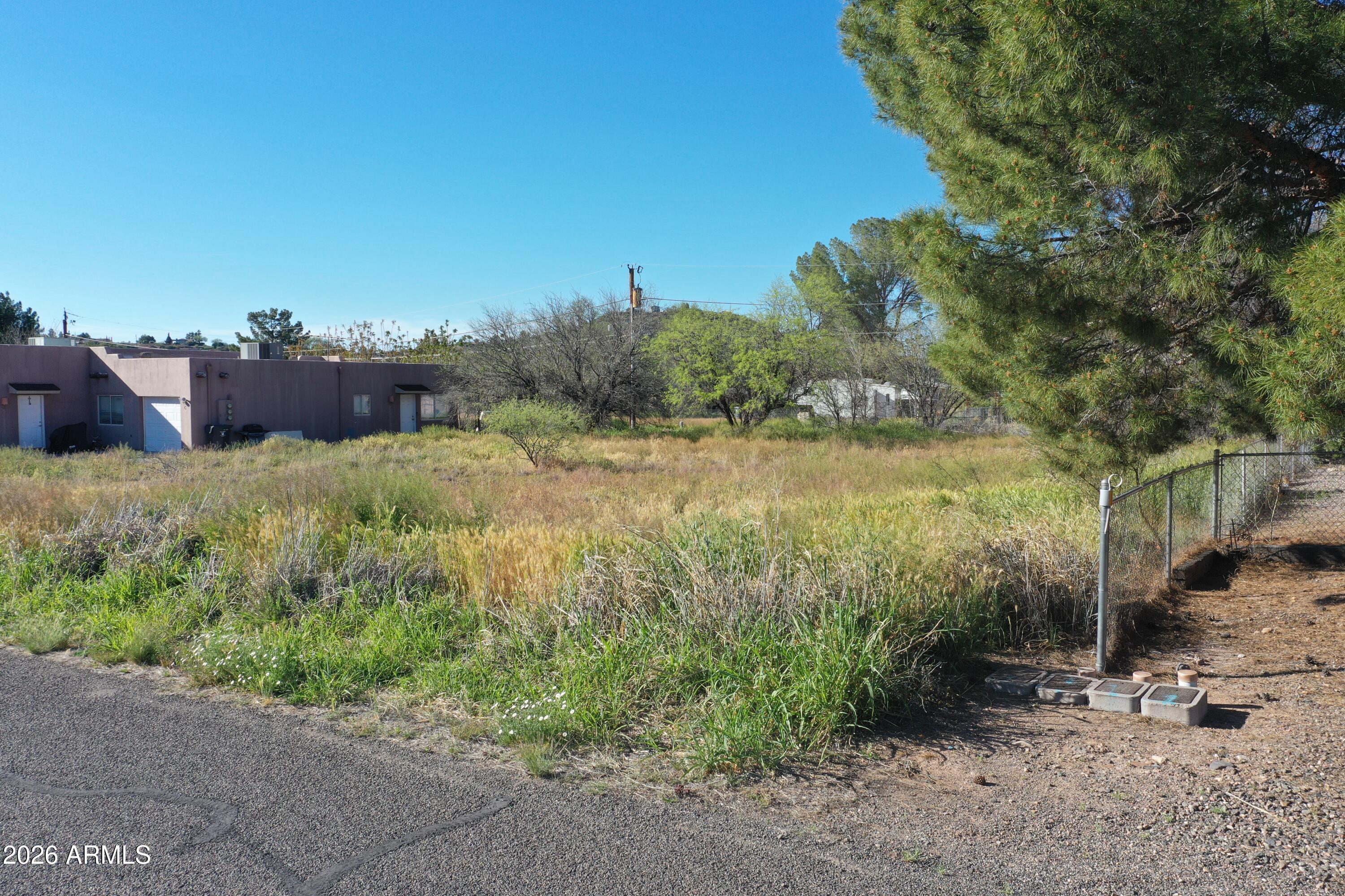3980 East Valley Lane, Unit 32 Rimrock, AZ 86335 - Photo 10 of 11 a view of a yard with plants and a bench