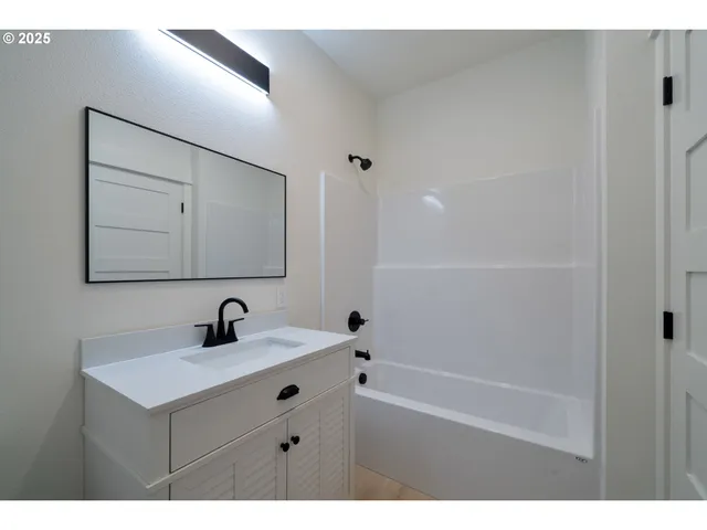 a view of an empty room and window with wooden floor