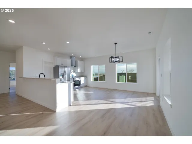 a kitchen with a refrigerator and a stove top oven