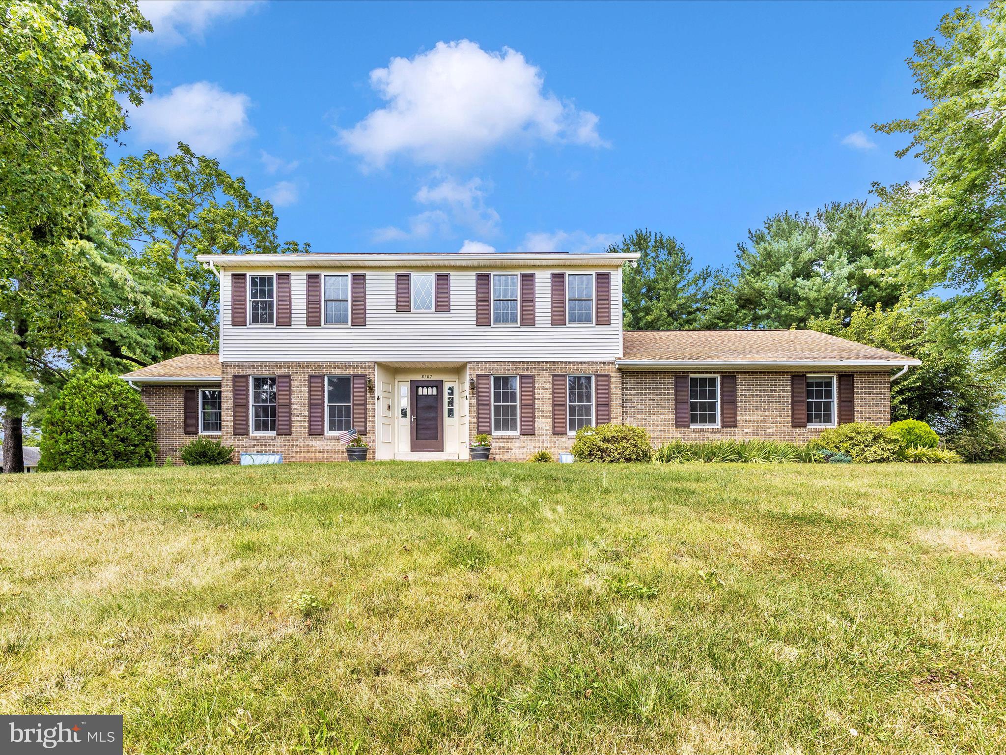 8107 Clearfield Road Frederick, MD 21702 - Photo 48 of 52 a front view of a house with a garden