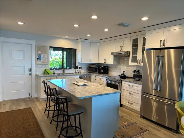 a living room with furniture and a flat screen tv with wooden floor