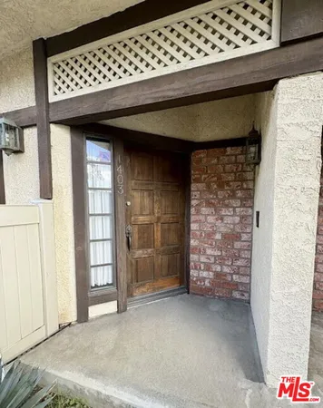 a view of a wooden door of the house