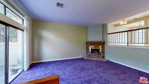 a view of empty room with floor to ceiling window