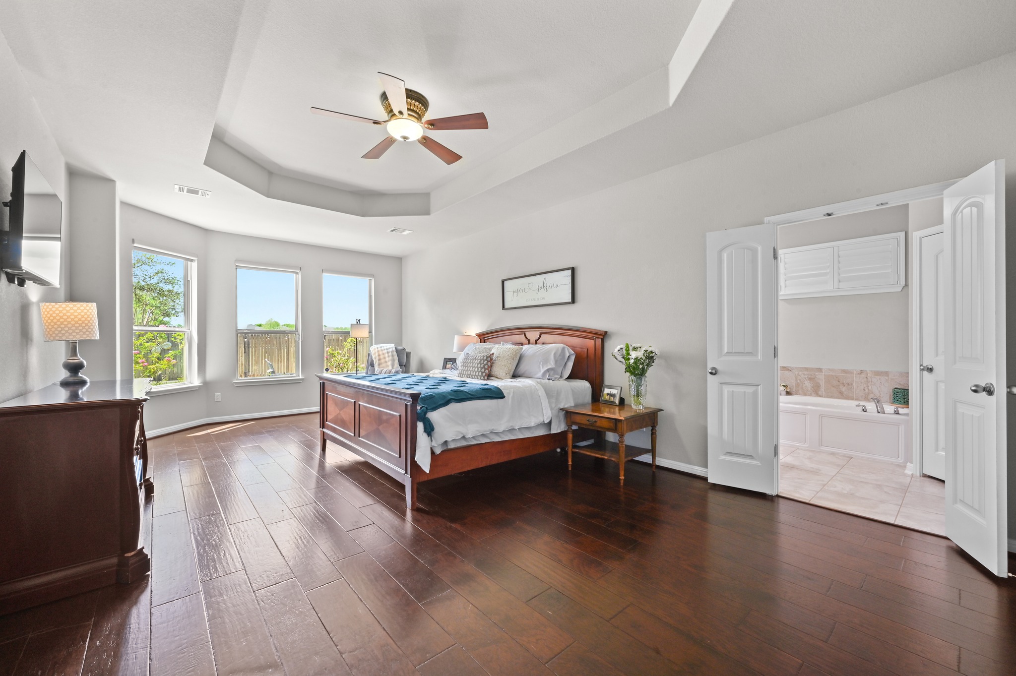 194 Treehaven Court Buda, TX 78610 - Photo 13 of 37 a bedroom with a bed and wooden floor