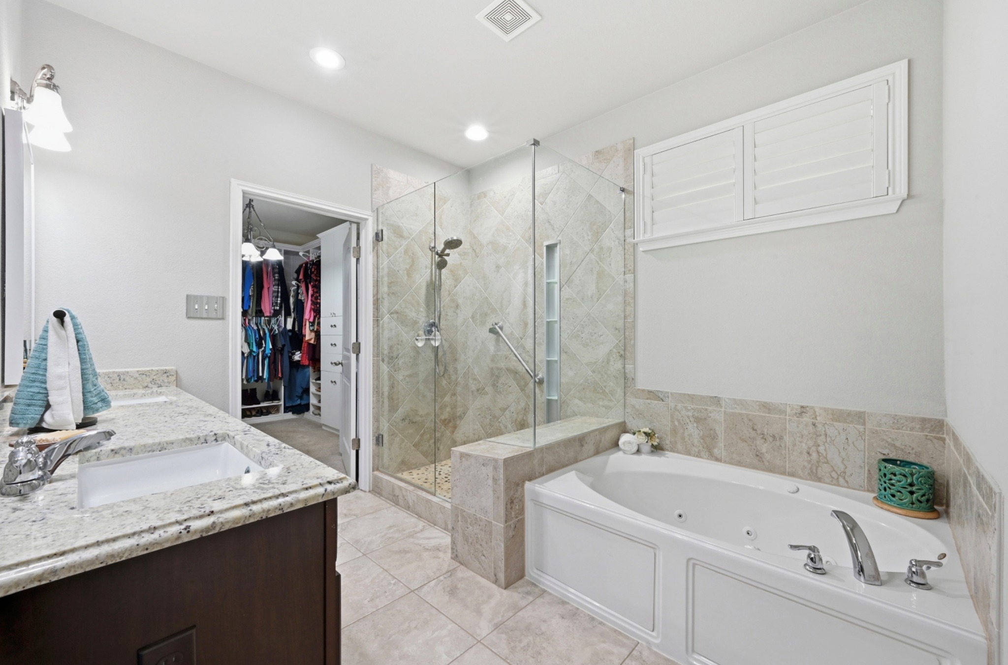 194 Treehaven Court Buda, TX 78610 - Photo 14 of 37 a bathroom with a granite countertop tub sink and mirror