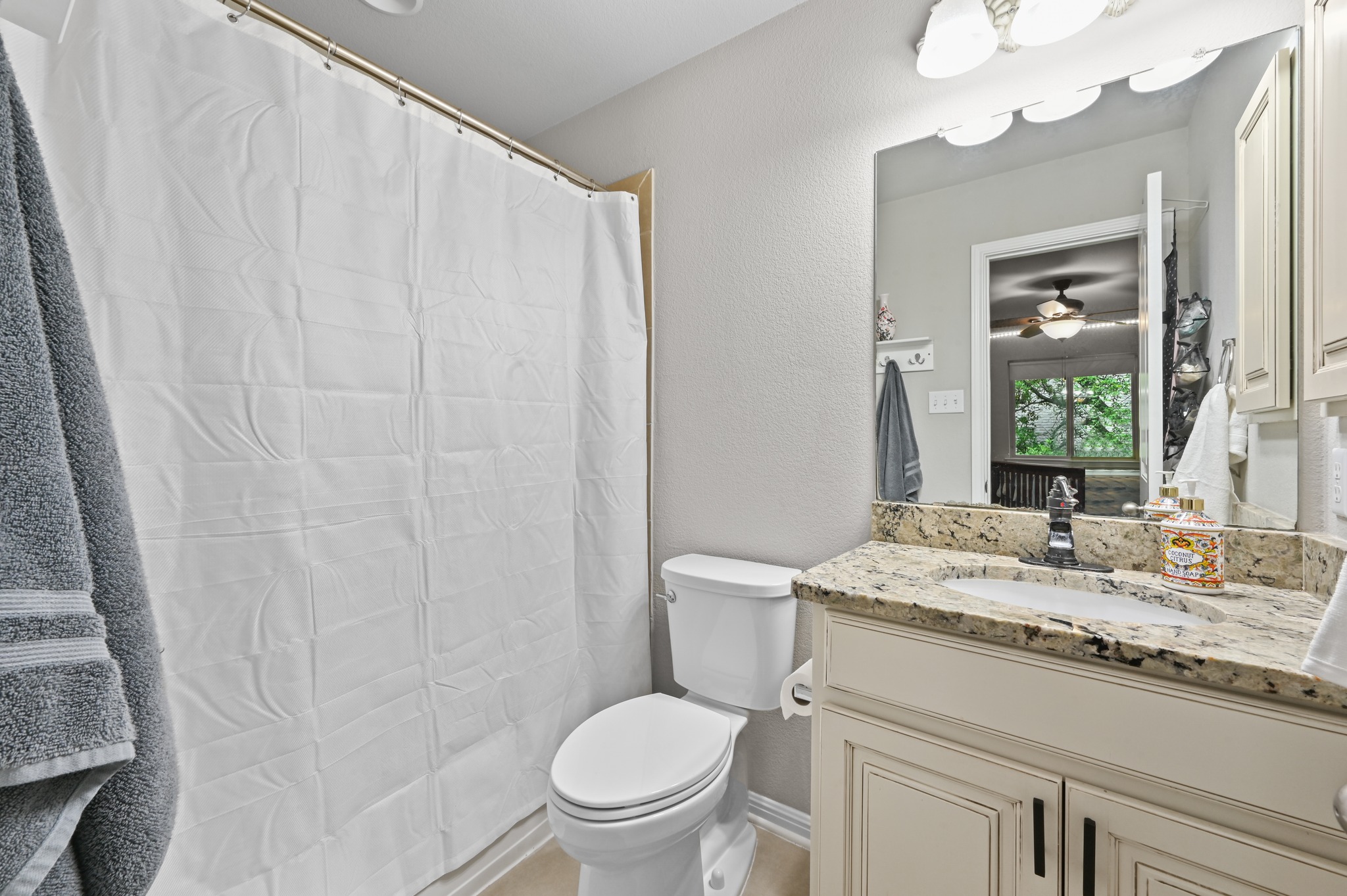 194 Treehaven Court Buda, TX 78610 - Photo 27 of 37 a bathroom with a granite countertop sink toilet and a mirror