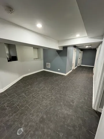 an empty room with a empty space and windows