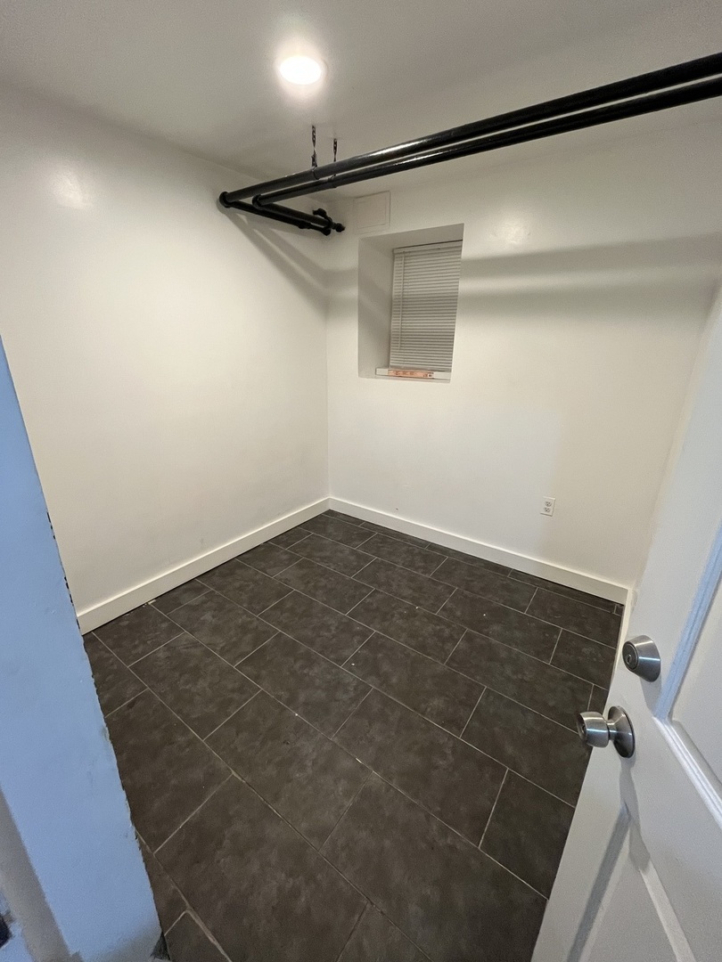 1922 South Springfield Avenue, Unit G Chicago, IL 60623 - Photo 8 of 10 a view of a room with racks on the wall