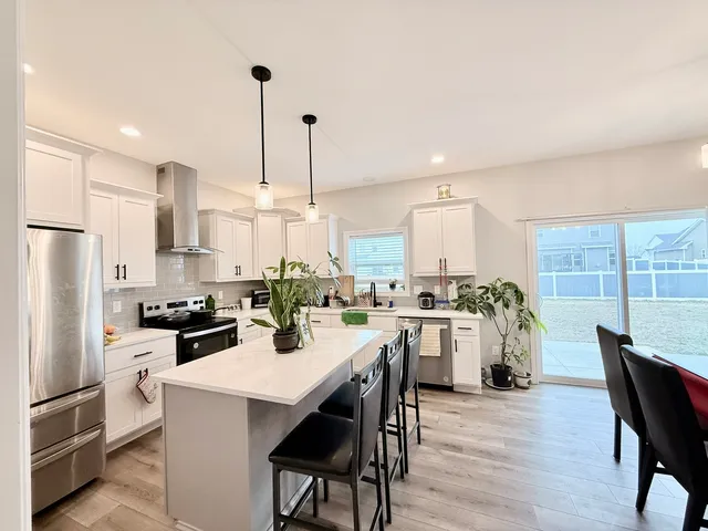 a kitchen with a table chairs stove and kitchen island