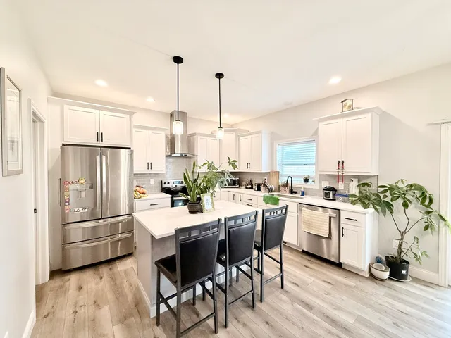 a kitchen with a sink appliances and cabinets