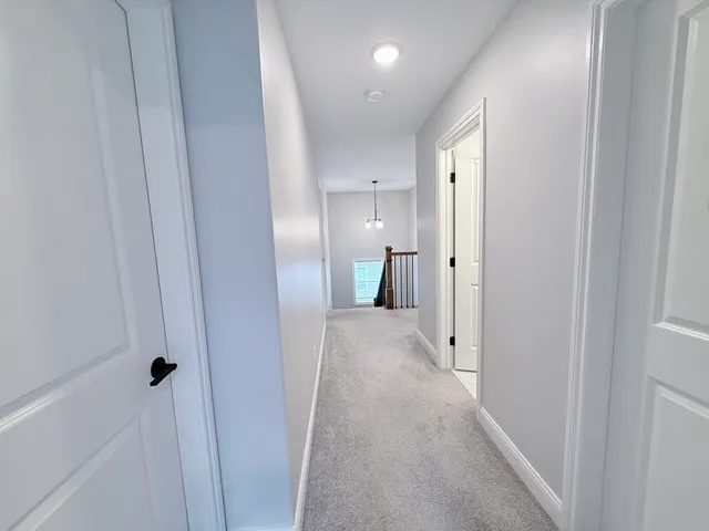 a bedroom with a bed a couch and a window