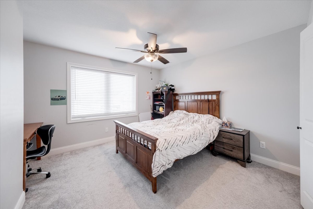 715 Rapp Drive Mahomet, IL 61853 - Photo 26 of 40 a bedroom with a bed chandelier and a window