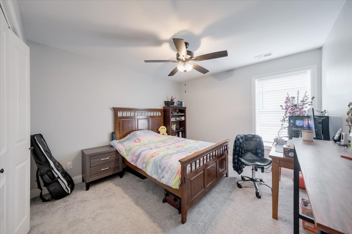 715 Rapp Drive Mahomet, IL 61853 - Photo 28 of 40 a bedroom with a bed a table and a chandelier