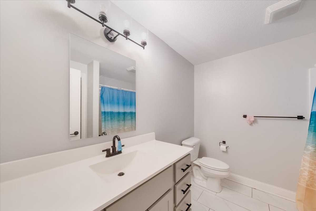 715 Rapp Drive Mahomet, IL 61853 - Photo 32 of 40 a bathroom with a sink a toilet and mirror