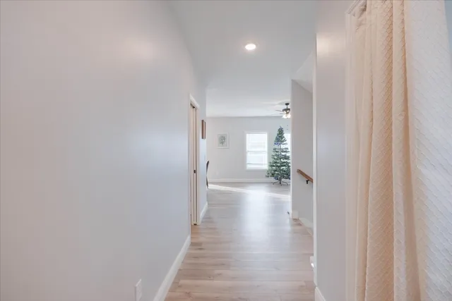 a view of a hallway with wooden floor