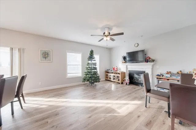 a living room with furniture a fireplace and a window