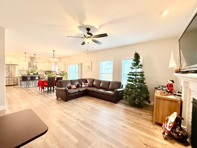 a living room with furniture and a chandelier