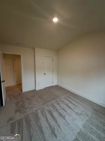a view of an empty room and a window
