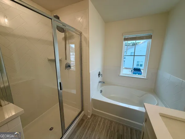 a bathroom with a bathtub and a shower