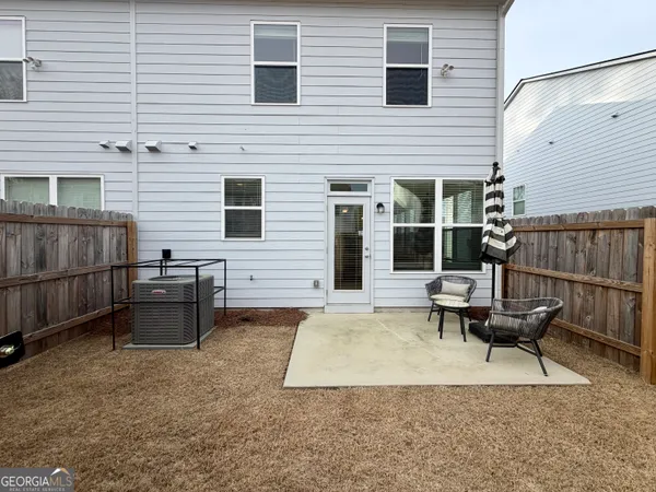 a view of a patio with a table and chairs