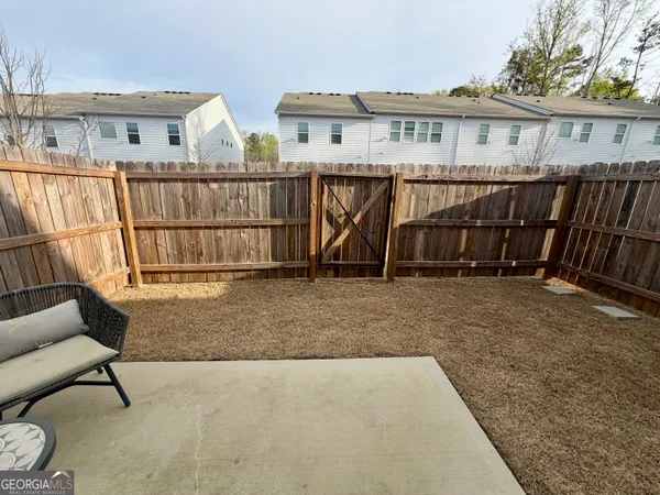 a view of a house with backyard and deck