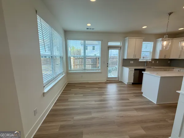 a view of a kitchen with a sink and cabinets