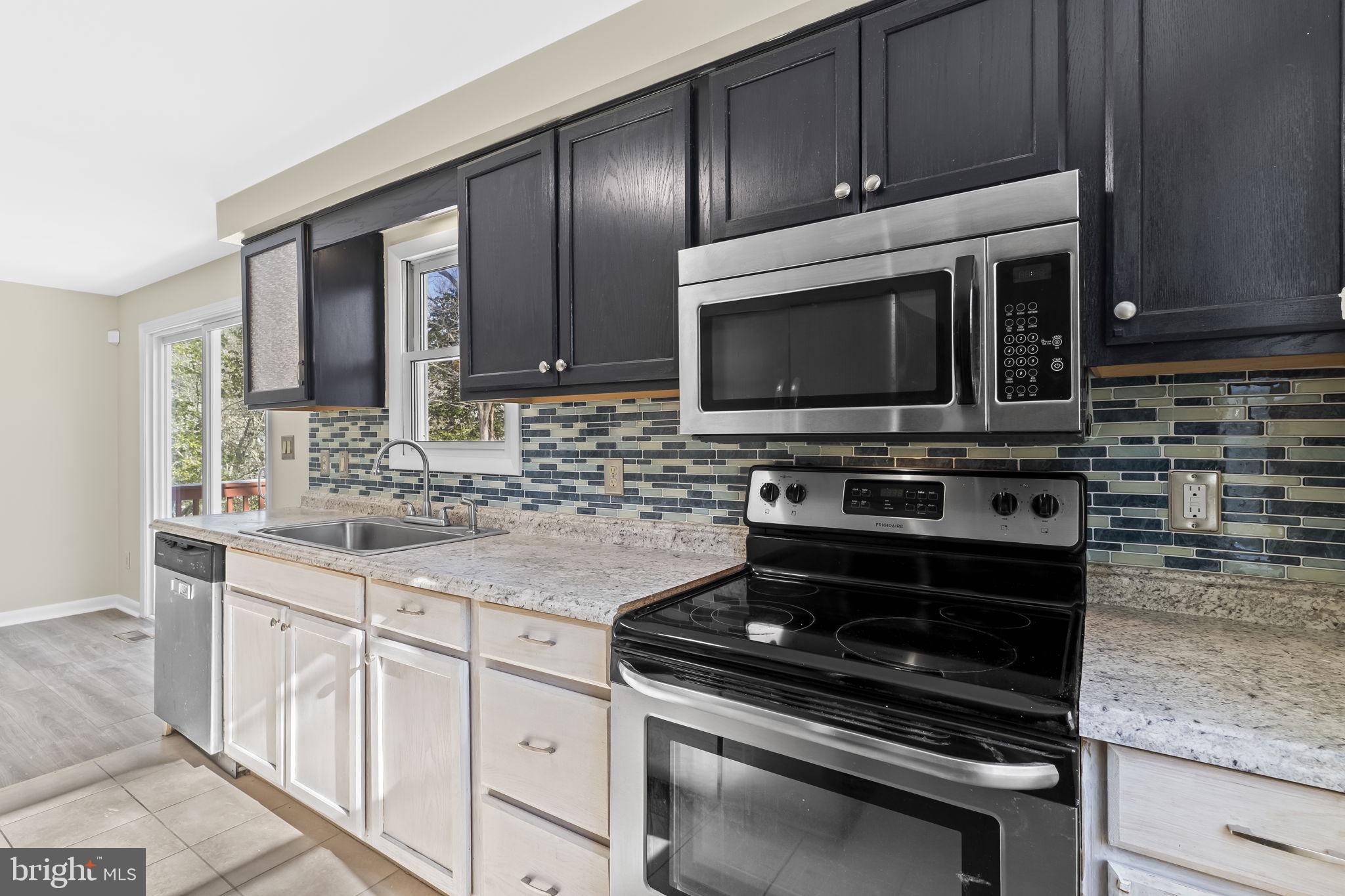 532 Shortbow Trail Lusby, MD 20657 - Photo 11 of 33 a kitchen with granite countertop a stove and a microwave