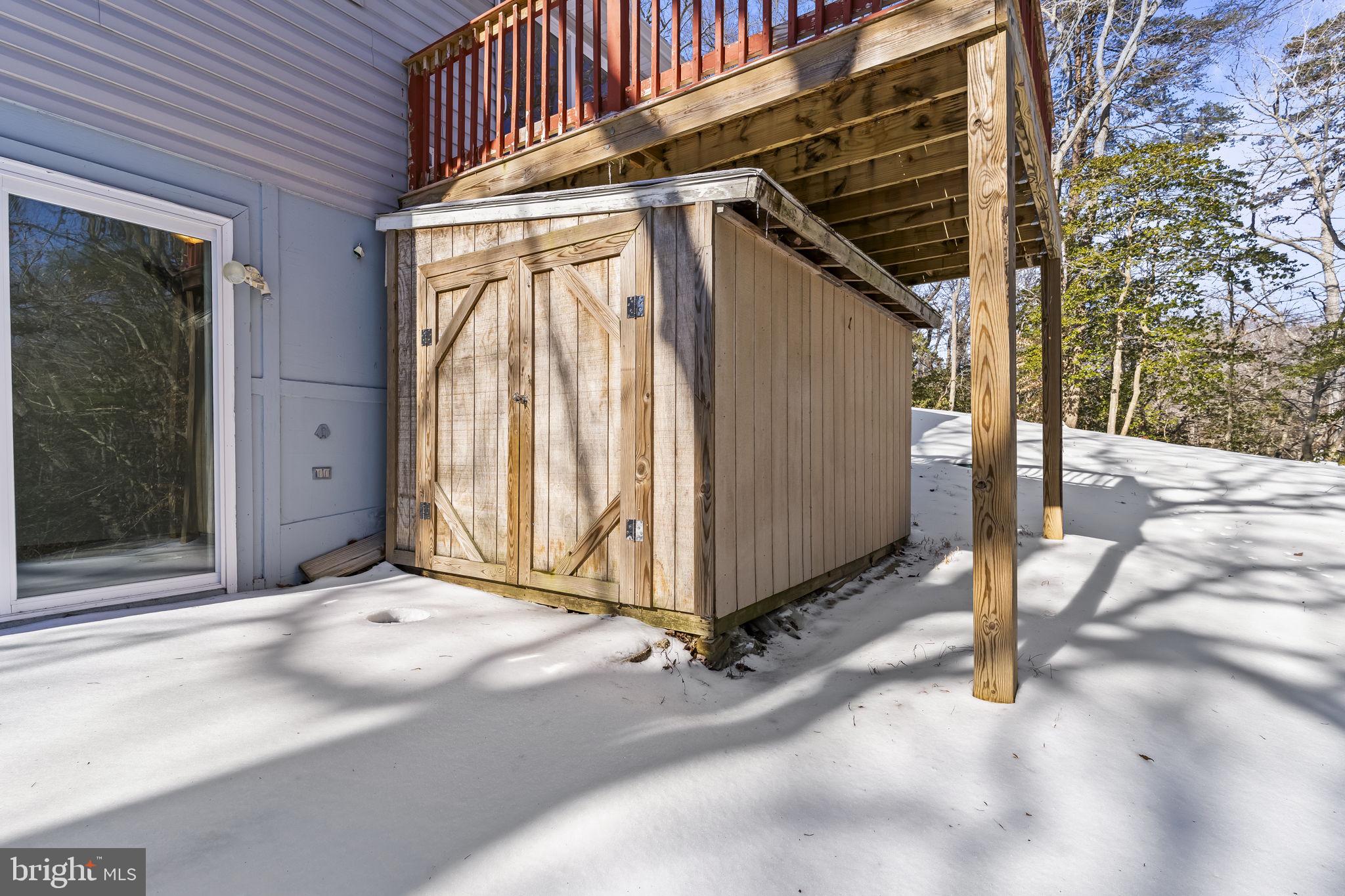 532 Shortbow Trail Lusby, MD 20657 - Photo 29 of 33 a view of a house with a door and wooden bench