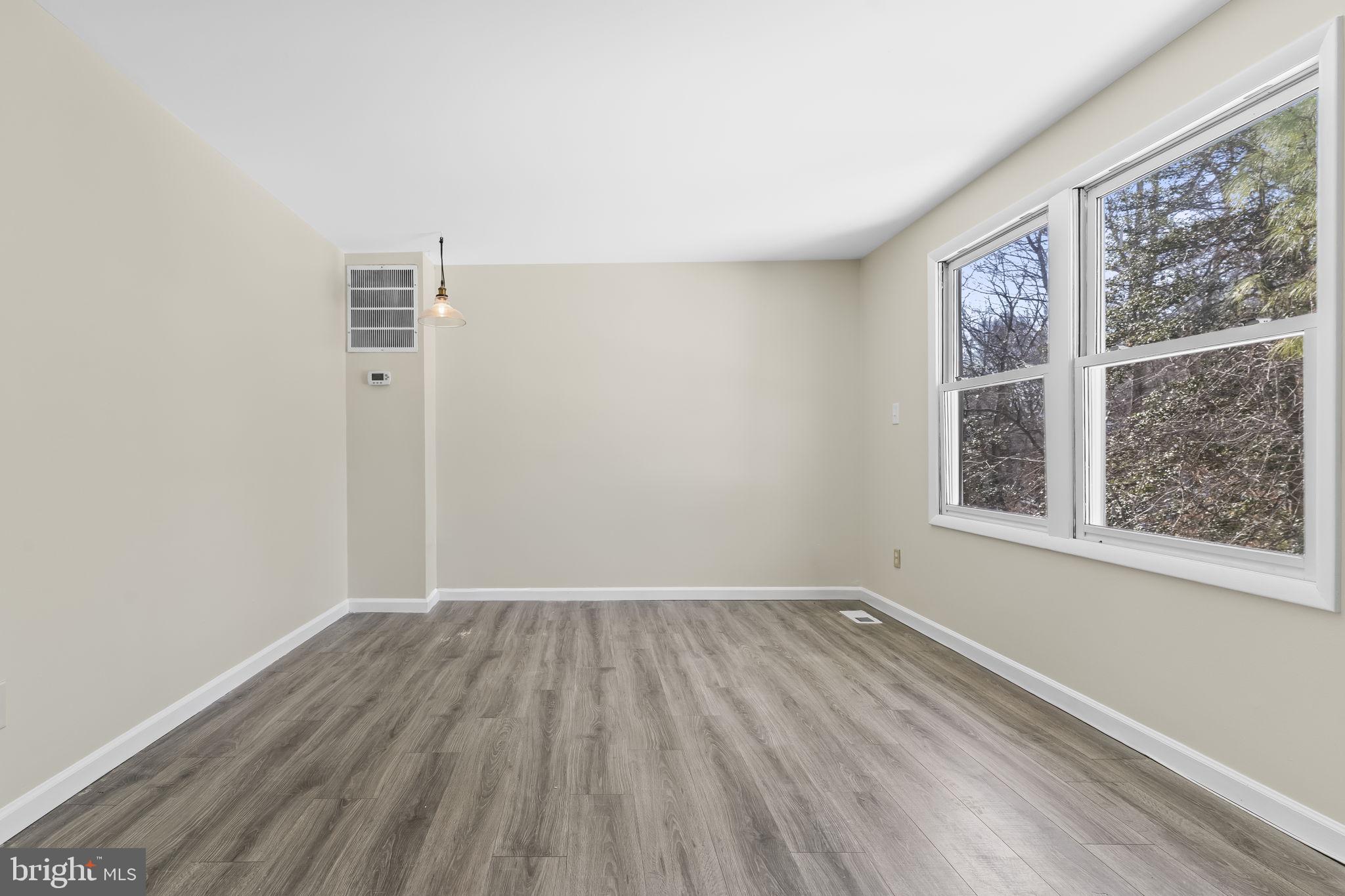 532 Shortbow Trail Lusby, MD 20657 - Photo 5 of 33 an empty room with wooden floor and windows