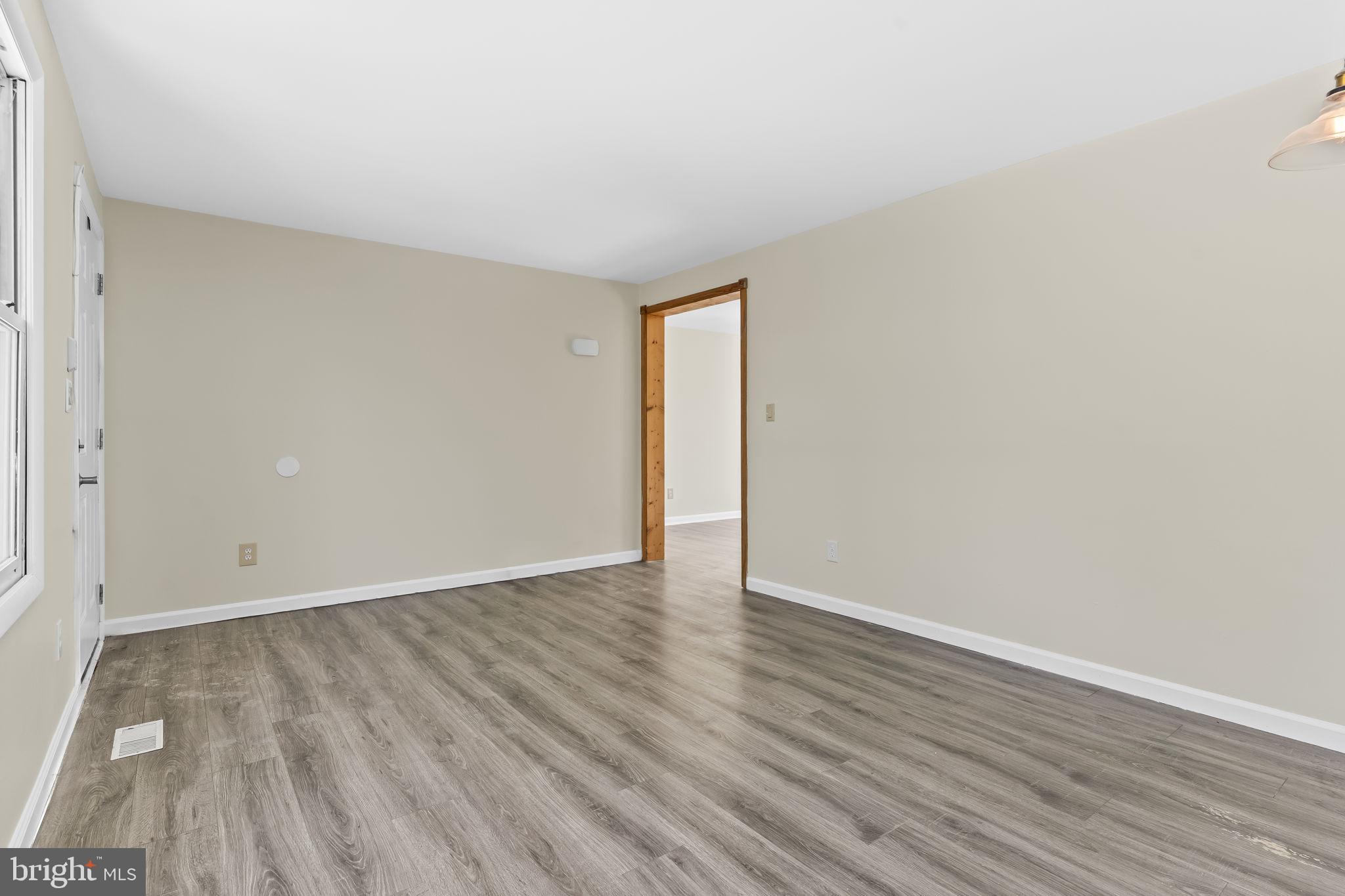 532 Shortbow Trail Lusby, MD 20657 - Photo 6 of 33 an empty room with wooden floor and windows