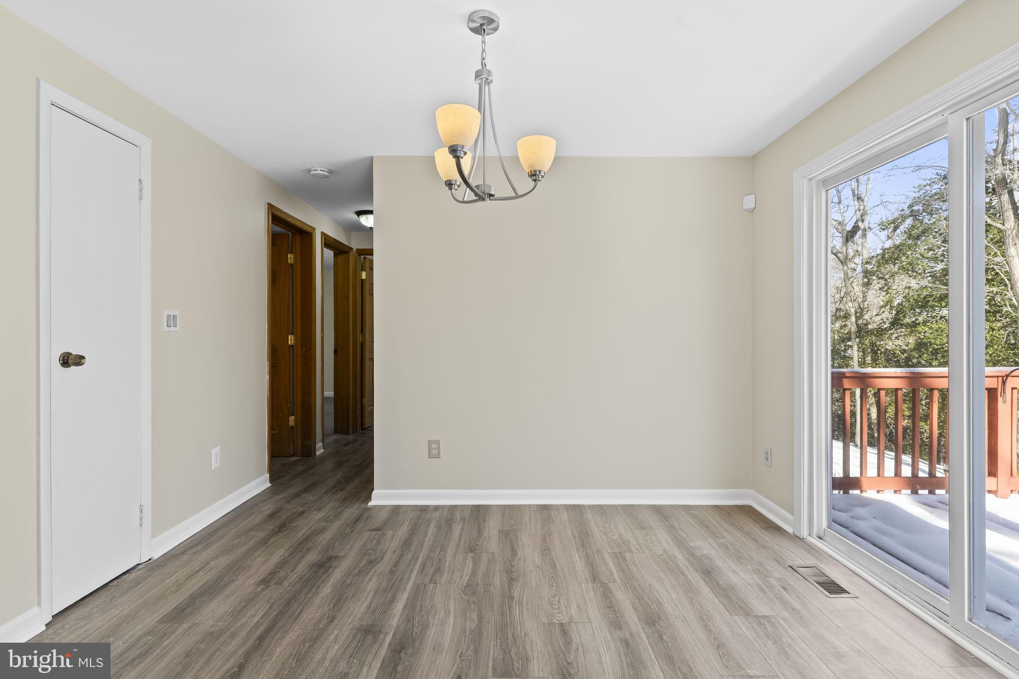 532 Shortbow Trail Lusby, MD 20657 - Photo 9 of 33 a view of an empty room with wooden floor and a window